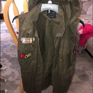 Dark green colored vest with patches